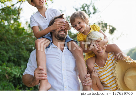 Family with small children in sunny summer nature having fun. 127629700