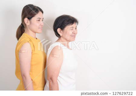 Adult and Elderly Woman with bandage after received vaccine. Vaccination and Immunization for Influenza, HPV, Zoster, IPD, DTP, Dengue, Encephalitis, Rabies, Pneumococcal Hepatitis B and Covid vaccine Adult and Elderly Woman with bandage after received vaccine. Vaccination and Immunization for Influenza, HPV, Zoster, IPD, DTP, Dengue, Encephalitis, Rabies, Pneumococcal Hepatitis B and Covid vaccine 127629722