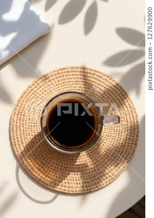 Coffee on Table with Sunlight and foliage shadows 127629900