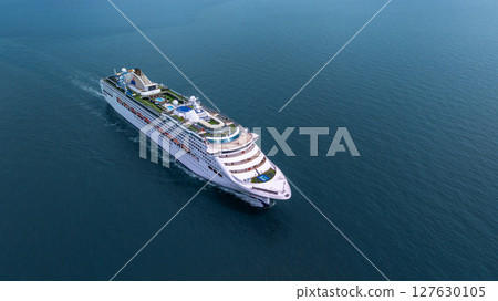 Aerial view luxury ocean cruise ship on clam blue sea, Elegant modern travel lifestyle, Luxury cruise ship liner modern maritime business ocean tourism, Global business cruise ship liner industry. Aerial view luxury ocean cruise ship on clam blue sea, Elegant modern travel lifestyle, Luxury cruise ship liner modern maritime business ocean tourism, Global business cruise ship liner industry. 127630105