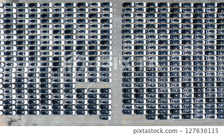 Aerial view of new ev cars stock at RoRo roll on roll off terminal international port, New electric vehicle ev cars parking lot, Automotive industry sea freight transportation logistic business. Aerial view of new ev cars stock at RoRo roll on roll off terminal international port, New electric vehicle ev cars parking lot, Automotive industry sea freight transportation logistic business. 127630115