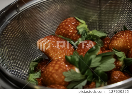 Strawberries drained in a colander 127630235