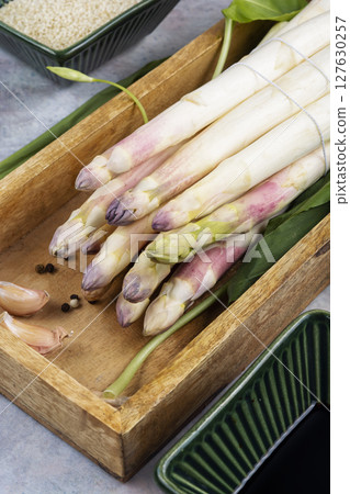 Raw white asparagus spears. 127630257