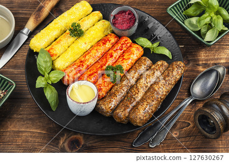 Fresh uncooked sausages on a plate. Fresh uncooked sausages on a plate. 127630267