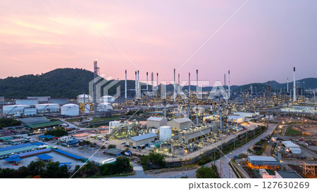 Aerial view oil and gas refinery plant at night, Global business energy logistic transportation, Oil and gas refinery petrochemical industrial, Petrochemical refinery industrial energy supply chain. Aerial view oil and gas refinery plant at night, Global business energy logistic transportation, Oil and gas refinery petrochemical industrial, Petrochemical refinery industrial energy supply chain. 127630269