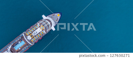 Aerial view luxury ocean cruise ship on clam blue sea, Elegant modern travel lifestyle, Luxury cruise ship liner modern maritime business ocean tourism, Global business cruise ship liner industry. Aerial view luxury ocean cruise ship on clam blue sea, Elegant modern travel lifestyle, Luxury cruise ship liner modern maritime business ocean tourism, Global business cruise ship liner industry. 127630271