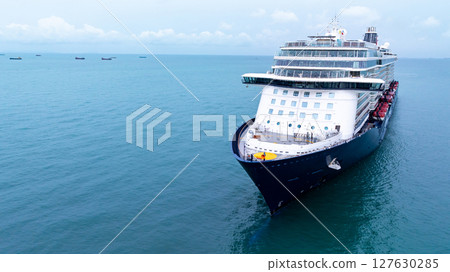 Aerial view luxury ocean cruise ship on clam blue sea, Elegant modern travel lifestyle, Luxury cruise ship liner modern maritime business ocean tourism, Global business cruise ship liner industry. Aerial view luxury ocean cruise ship on clam blue sea, Elegant modern travel lifestyle, Luxury cruise ship liner modern maritime business ocean tourism, Global business cruise ship liner industry. 127630285
