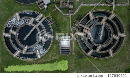 Aerial view westewater treatment tank with wastewater, Circle circular water clarifier cleaning water, Circle water treatment plant circular clarifier, Water treatment plant. Aerial view westewater treatment tank with wastewater, Circle circular water clarifier cleaning water, Circle water treatment plant circular clarifier, Water treatment plant. 127630331