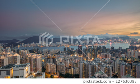 June 8 2025 View of a Modern Cityscape by a Serene River at Sunset 127630385