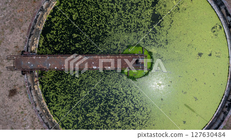 Aerial view westewater treatment tank with wastewater, Circle circular water clarifier cleaning water, Circle water treatment plant circular clarifier, Water treatment plant. 127630484