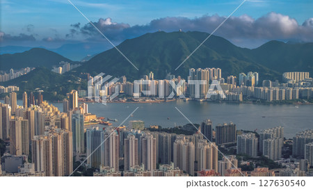 June 8 2025 Urban Skyline with Mountains and Waterfront in Vibrant Cityscape 127630540
