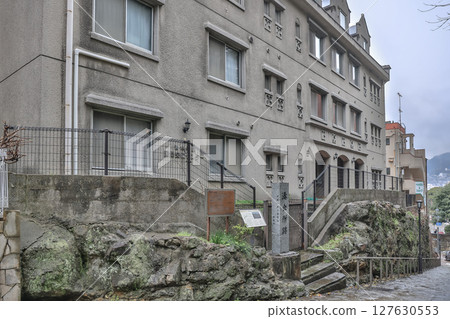 March 28 2025 Historic Stone Monument and Building Facade in Urban Setting 127630553