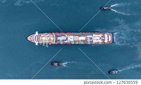 Aerial view luxury ocean cruise ship on clam blue sea, Elegant modern travel lifestyle, Luxury cruise ship liner modern maritime business ocean tourism, Global business cruise ship liner industry. Aerial view luxury ocean cruise ship on clam blue sea, Elegant modern travel lifestyle, Luxury cruise ship liner modern maritime business ocean tourism, Global business cruise ship liner industry. 127630559