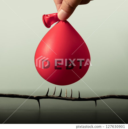 A water-filled balloon labeled DEBT hovers dangerously above spikes, symbolizing risk, debt crisis, financial instability and economic collapse 127630901