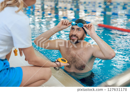 Man having a workout in the swimming pool Man having a workout in the swimming pool 127631178