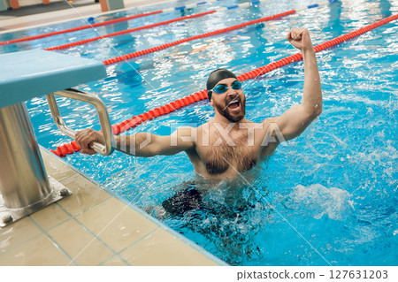 Man in swimming pool feeling excited and happy Man in swimming pool feeling excited and happy 127631203