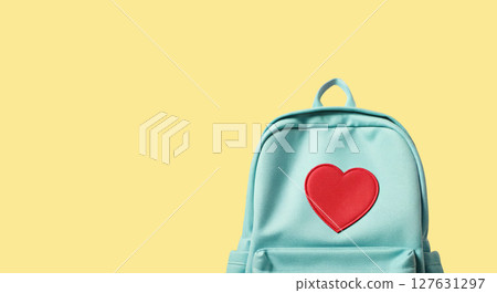 A mint blue backpack with a pink heart patch, pastel color palette, cute school supply 127631297