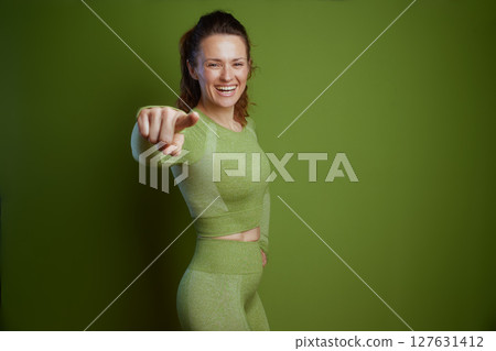 Engaging woman in green pointing at viewer Engaging woman in green pointing at viewer 127631412