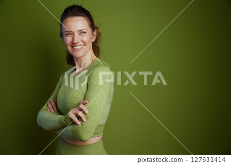 Self-assured woman in green athletic wear Self-assured woman in green athletic wear 127631414