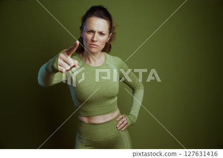 Stern fitness coach in green activewear Stern fitness coach in green activewear 127631416