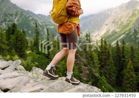 Close-up of female legs in hiking boots on a hiking trail. Travel, vacation. The concept of nature. 127631450