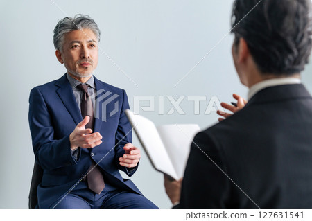 Middle-aged male business person being interviewed Middle-aged male business person being interviewed 127631541