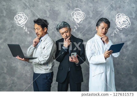 Group of middle-aged men from various professions having trouble with digital devices Group of middle-aged men from various professions having trouble with digital devices 127631573