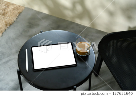 Digital tablet with blank screen, stylus, and coffee cup on modern black table Digital tablet with blank screen, stylus, and coffee cup on modern black table 127631640