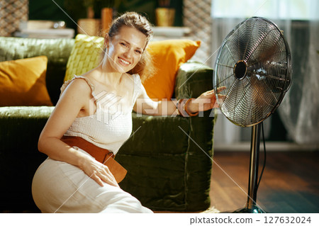 Relaxed Woman Enjoying Fan\'s Coolness 127632024