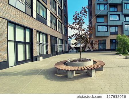 Architecture, modern real estate, residential apartment building, bench with tree, urban environment Architecture, modern real estate, residential apartment building, bench with tree, urban environment 127632056