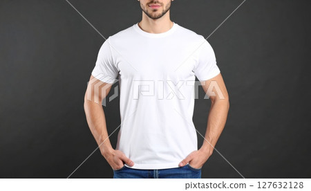 Handsome young man in a white t-shirt, confidently posing with a genuine smile Handsome young man in a white t-shirt, confidently posing with a genuine smile 127632128