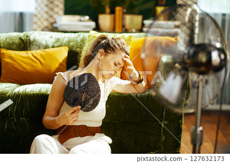 Heat Headache: Woman Seeks Relief Indoors Heat Headache: Woman Seeks Relief Indoors 127632173