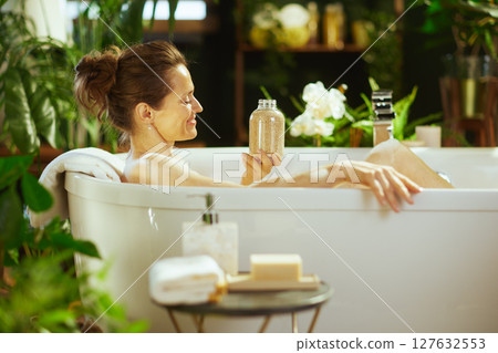 Relaxed Woman Enjoying a Soothing Bath Relaxed Woman Enjoying a Soothing Bath 127632553