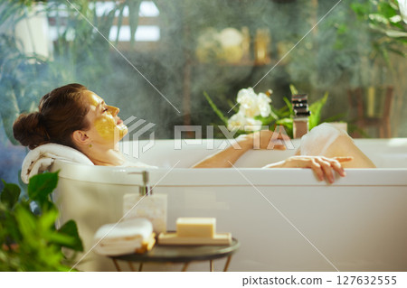 Woman with Face Mask: Serene Bath Ritual 127632555