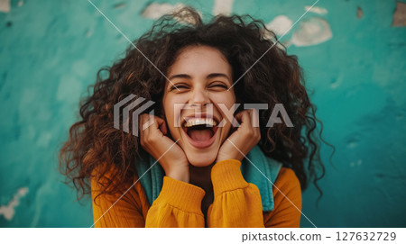 Joyful woman laughing with hands on face. 127632729