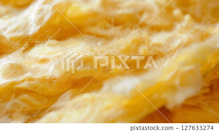 Close-up of soft, fibrous yellow material. 127633274