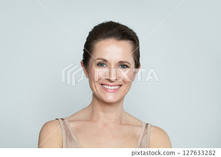 Charming mid aged mature woman looking at camera and smiling. Healthy face skin care beauty Charming mid aged mature woman looking at camera and smiling. Healthy face skin care beauty 127633282