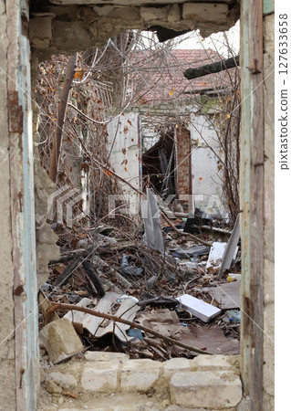 View thru the door in a room of a ruined house. 127633658