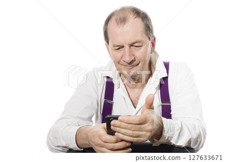 Portrait of a sixty-year-old man in a white shirt. 127633671