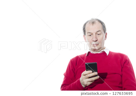 Portrait of a sixty-year-old man in a red pullover. 127633695