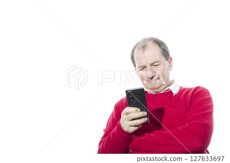 Portrait of a sixty-year-old man in a red pullover. 127633697
