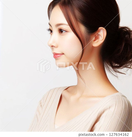 Profile of a woman with her hair tied up 127634162
