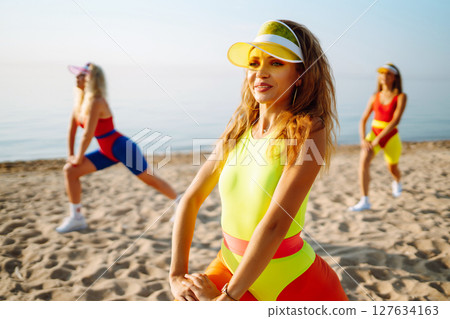 Young dancers in colorful swimsuits are dancing in morning. ?oncept of sports, fitness Active sport. 127634163
