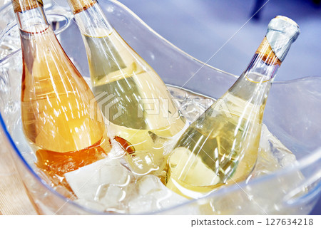 Champagne bottles in ice water Champagne bottles in ice water 127634218