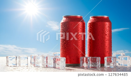 Two red chilled beverage cans with water drops. Refreshing soft drink with ice cube under bright sunny sky. Cool drink for summer Two red chilled beverage cans with water drops. Refreshing soft drink with ice cube under bright sunny sky. Cool drink for summer 127634485