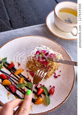 Elegant Dessert with Berries and Tea on Table Elegant Dessert with Berries and Tea on Table 127634569