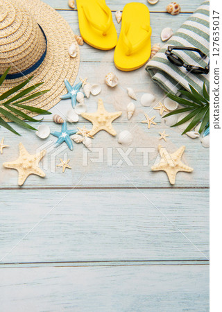Summer accessories creating a frame on a wooden background with copy space 127635017