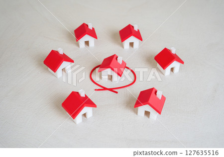 One house is outlined in red among many. One house is outlined in red among many. 127635516