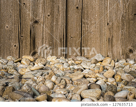 A textured mixed background featuring smooth pebbles in various shades of gray and brown, set against a rustic A textured mixed background featuring smooth pebbles in various shades of gray and brown, set against a rustic 127635713