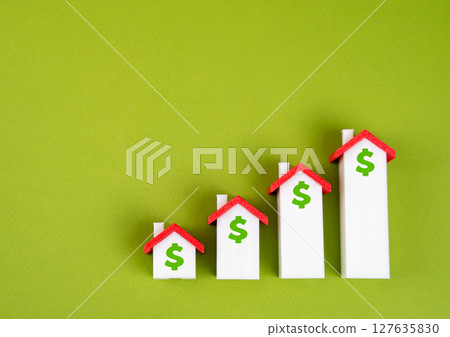 Houses in the form of a graph of housing price growth. Rising property prices 127635830